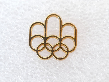 Odznaka Letnie Igrzyska Olimpijskie Montreal 1976 logo, pozłacana (produkt oficjalny)